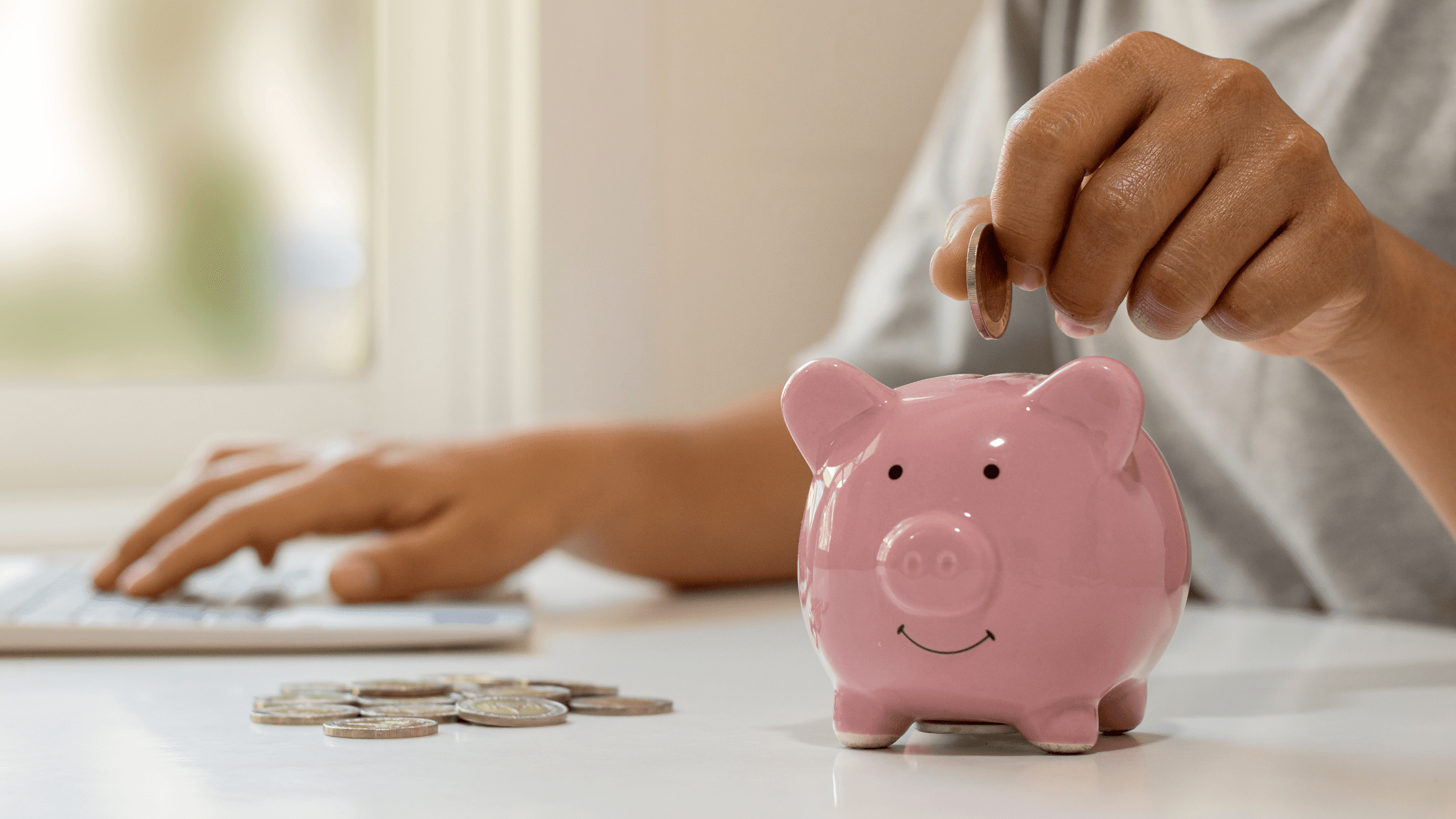 someone putting coins into a piggy bank and saving money on residency applications